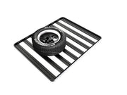 Front Runner spare wheel with low profile clamp resting on black and white striped surface