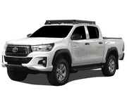 White Toyota Hilux pickup truck with Front Runner roof rack kit and low profile roof rack