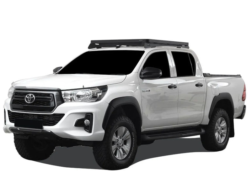 White Toyota Hilux pickup truck with Front Runner roof rack kit and low profile roof rack