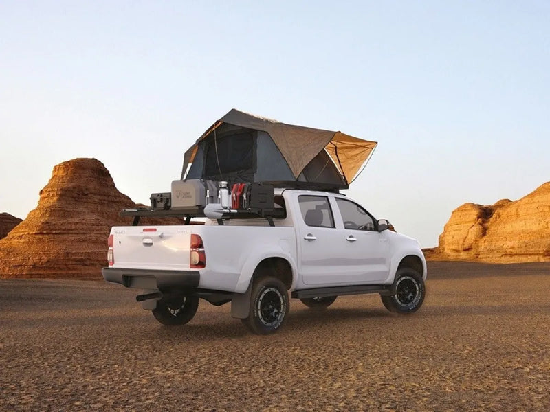 White pickup truck with rooftop tent on Slimline II tray roof rack kit for Toyota Hilux