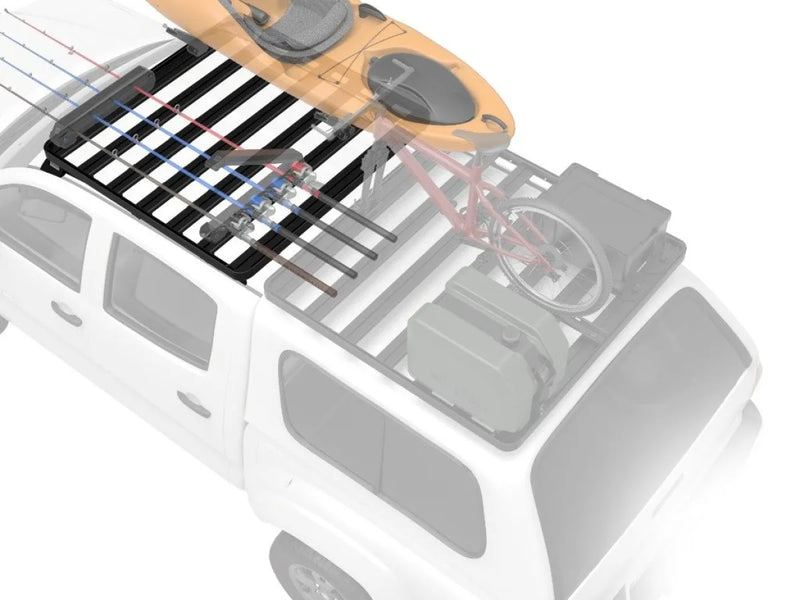 Roof rack kit with outdoor gear mounted on a Toyota Hilux for adventure travel