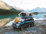 SUV with rooftop tent on Front Runner Toyota Land Cruiser 100 Slimline II roof rack kit by scenic lake