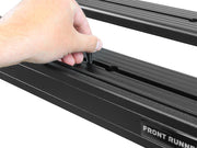Adjustable roof rack or cargo carrier being installed on a Front Runner Toyota Land Cruiser 60 Slimline II roof rack kit