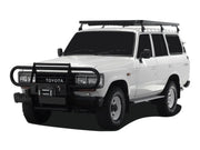 White Toyota Land Cruiser SUV with Front Runner Tall Slimline II roof rack kit and bull bar