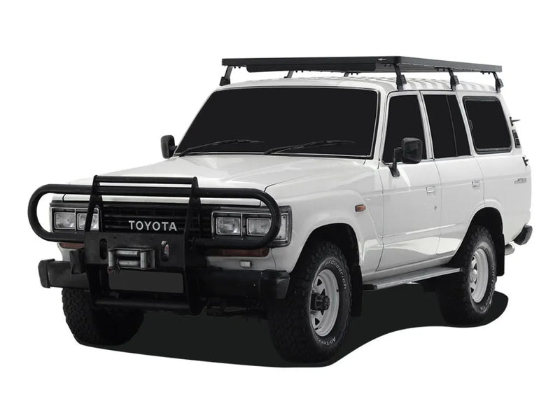 White Toyota Land Cruiser SUV with Front Runner Tall Slimline II roof rack kit and bull bar