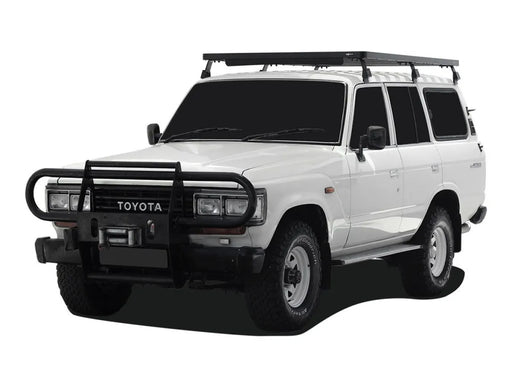 White Toyota Land Cruiser SUV with Front Runner Tall Slimline II roof rack kit and bull bar