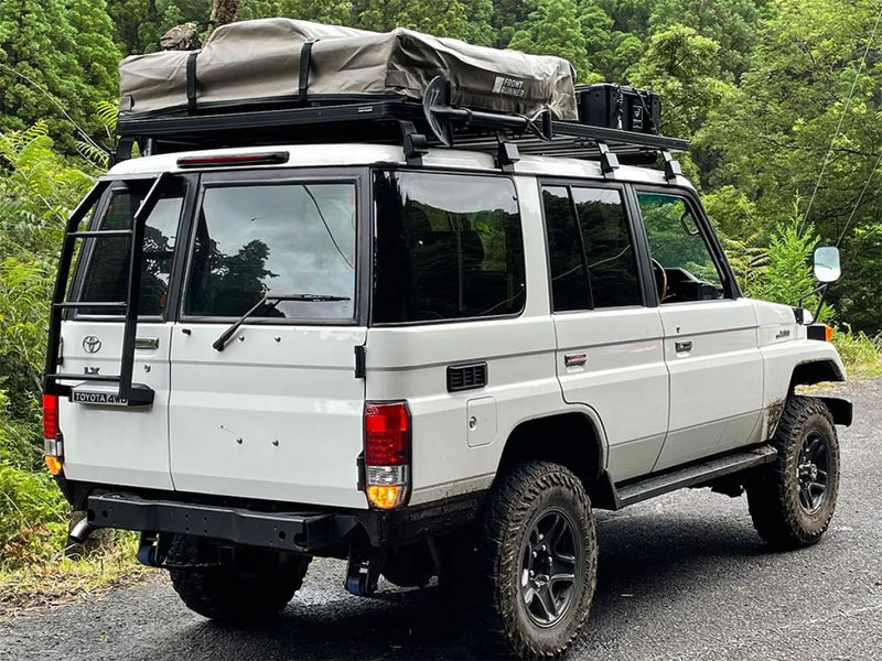 White Toyota Land Cruiser with Front Runner Slimline II tray roof rack kit for off-road adventures