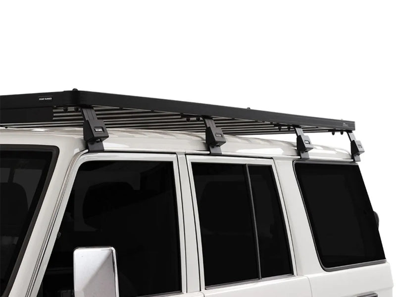 Roof rack kit installed on a white Toyota Land Cruiser 76 for outdoor adventure storage