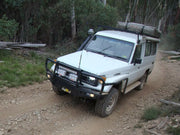 Off-road vehicle with roof rack kit on dirt path suitable for Toyota Land Cruiser 78