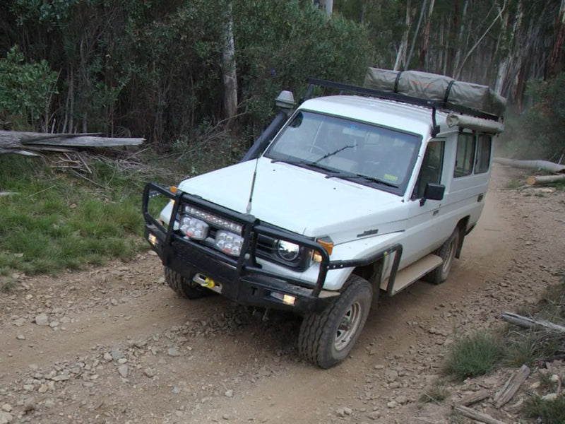 Off-road vehicle with roof rack kit on dirt path suitable for Toyota Land Cruiser 78