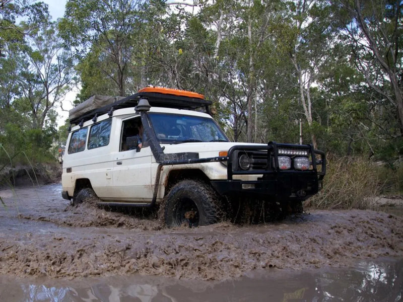 Off-road vehicle stuck in deep mud with Front Runner Toyota Land Cruiser 78 roof rack kit