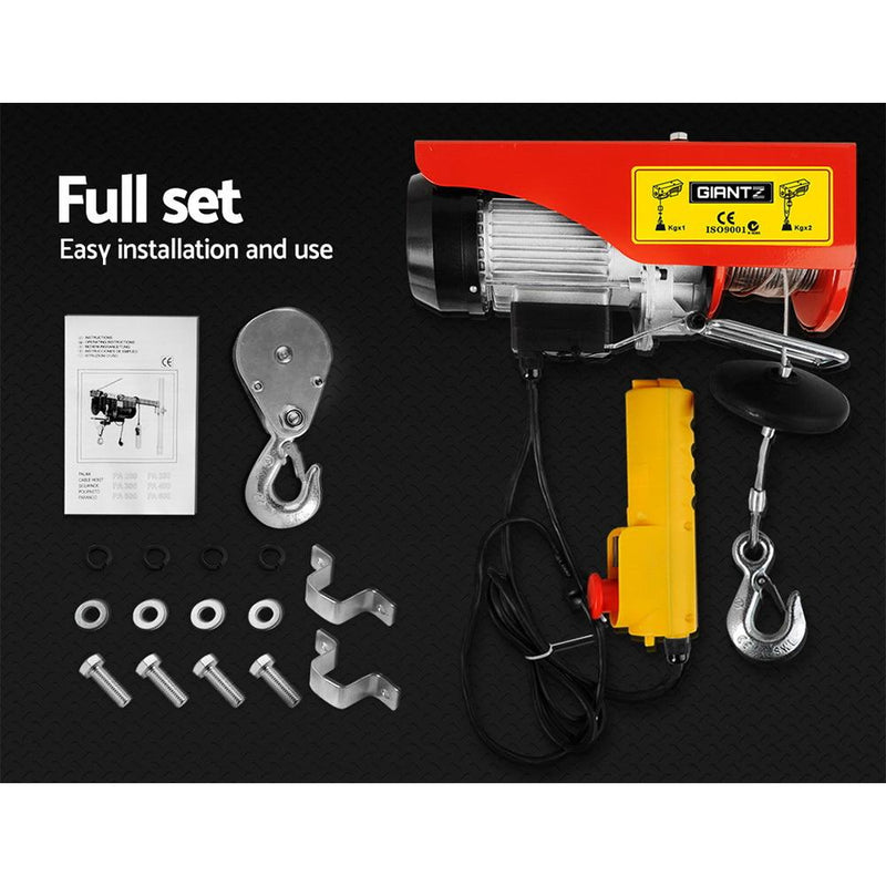 Electric hoist with accessories and installation components on a black surface for Giantz 1200w electric hoist winch