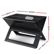 Portable folding charcoal BBQ grill with labeled dimensions for easy transport and use