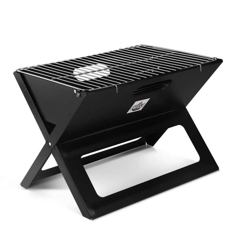 Portable charcoal bbq grill with black X-shaped frame and metal grate for outdoor cooking
