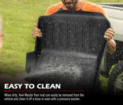 Black plastic car floor mats being cleaned with water spray for Mitsubishi Pajero Sport