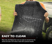 Black rubber Ford Ranger car floor mats being cleaned with water spray
