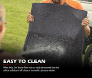 Black rubber car floor mats being sprayed with water showing easy-to-clean feature for Toyota Hilux dual