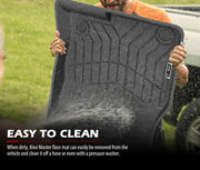 Black rubber car floor mats with textured pattern being cleaned outdoors for Mazda CX-5 KF