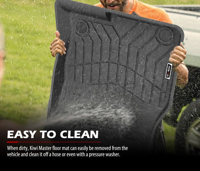 Black rubber car floor mats with textured pattern being cleaned outdoors for Mazda CX-5 KF