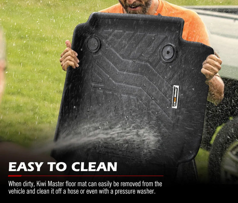 Black rubber car floor mats being cleaned with water for Kiwi Master 3D TPE Car Floor Mats