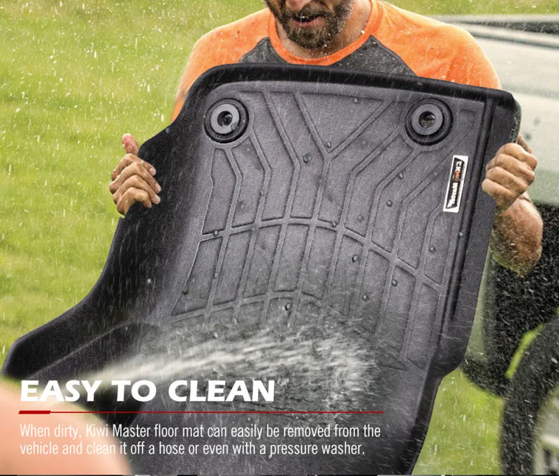 Black rubber car floor mats for Toyota Landcruiser 76 Series being washed with water