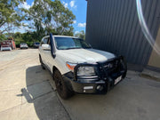 White SUV with heavy-duty bumper guard showcasing Meredith stainless steel snorkel kit for Landcruiser