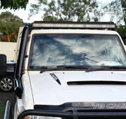 White Toyota Land Cruiser with roof-mounted light bar and Meredith stainless steel snorkel