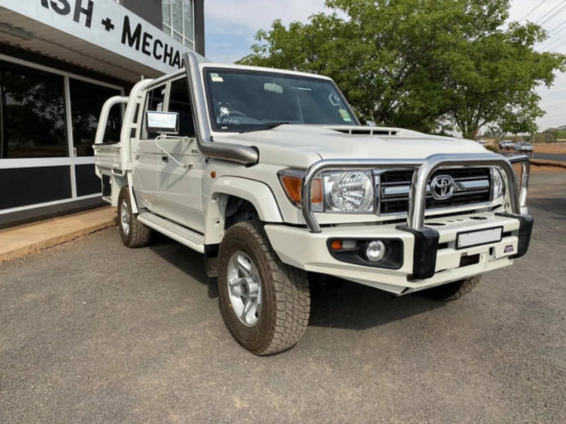 White Toyota Land Cruiser pickup truck with stainless steel snorkel and bull bar