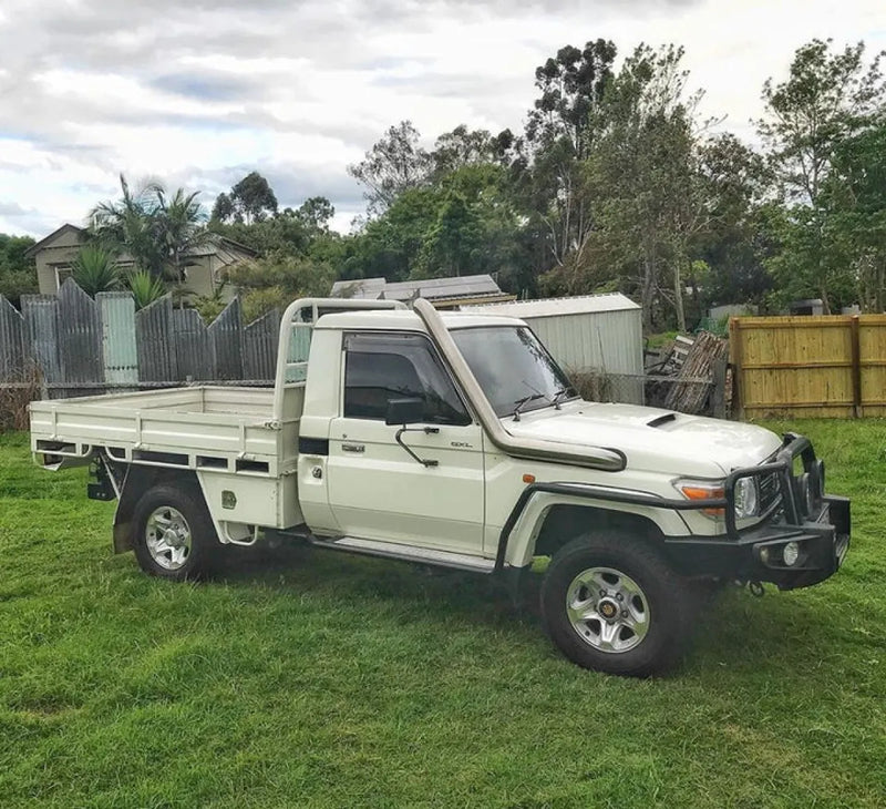 Toyota Land Cruiser pickup truck with flatbed featuring Meredith Stainless Steel 4 Snorkel Kit