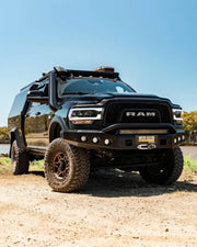 Heavily modified black RAM 2500 5th gen truck with off-road upgrades and stainless steel snorkel kit