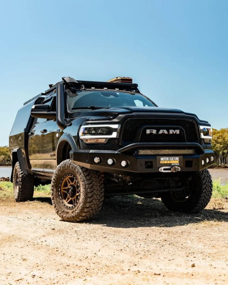 Heavily modified black RAM 2500 5th gen truck with off-road upgrades and stainless steel snorkel kit