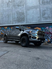 Stainless steel 5th gen snorkel kit on rugged black RAM 2500 pickup with oversized tires