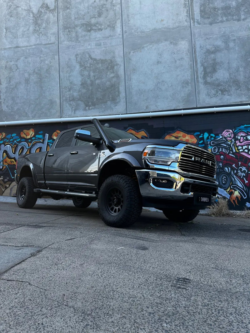 Stainless steel 5th gen snorkel kit on rugged black RAM 2500 pickup with oversized tires