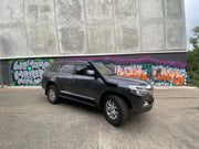 Black SUV with stainless steel snorkel parked in front of graffiti wall