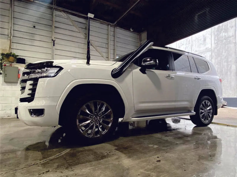 White luxury SUV with sleek styling and alloy wheels featuring stainless steel snorkel for Toyota 300 Series Landcruiser