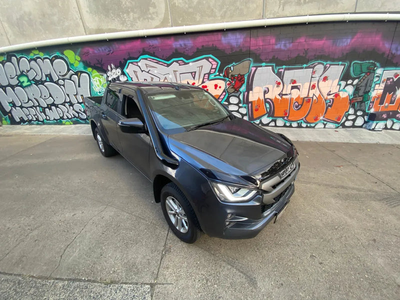 Gray pickup truck with stainless steel snorkel parked in front of graffiti wall for Isuzu DMAX