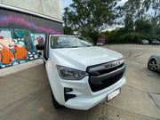 White Isuzu DMAX pickup truck with stainless steel snorkel parked near graffitied wall