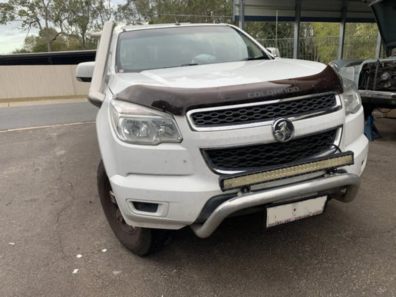 White Holden Colorado pickup truck with damaged front bumper featuring Meredith stainless steel snorkel