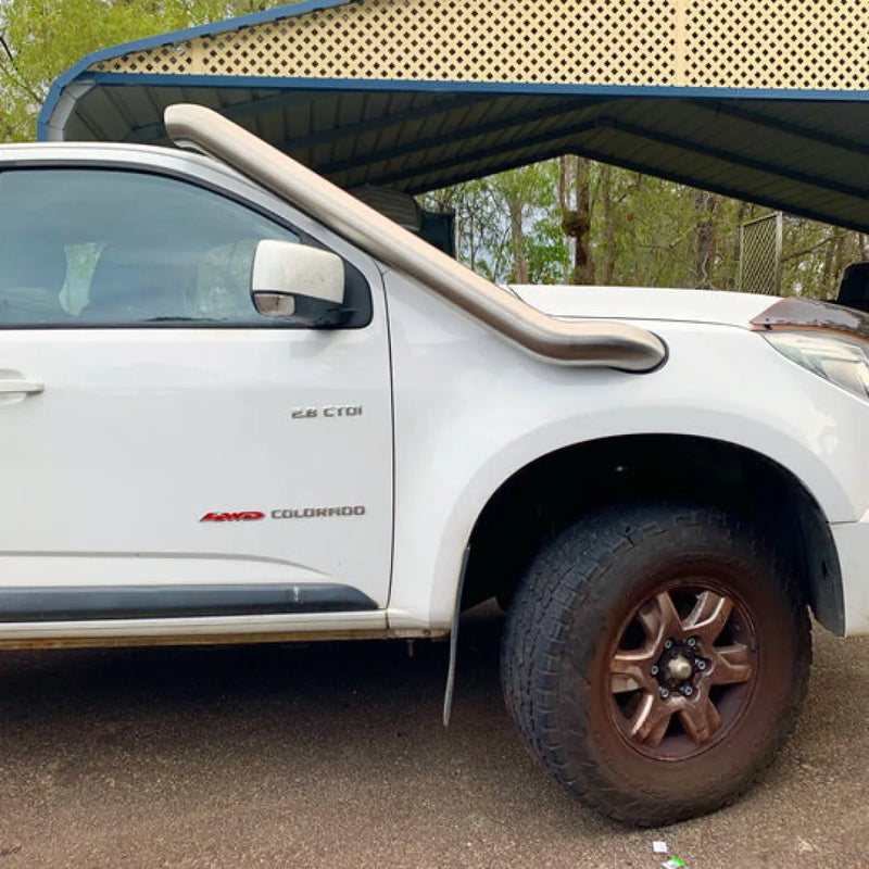 White Toyota Hilux pickup truck with stainless steel snorkel kit for off-road adventures