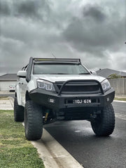 White pickup truck with oversized tires and custom bumper featuring Meredith stainless steel snorkel kit
