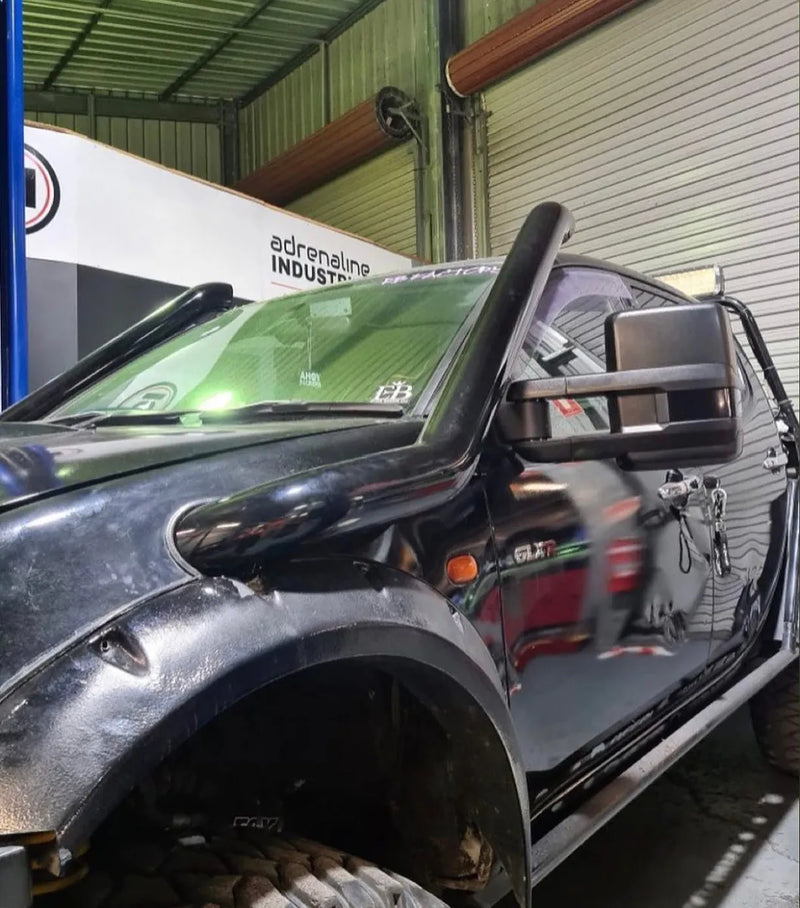 Silver pickup truck with exposed door frame showcasing stainless steel snorkel installation