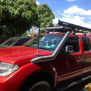 Red pickup truck with stainless steel snorkel and roof rack, suited for Nissan D40 Navara
