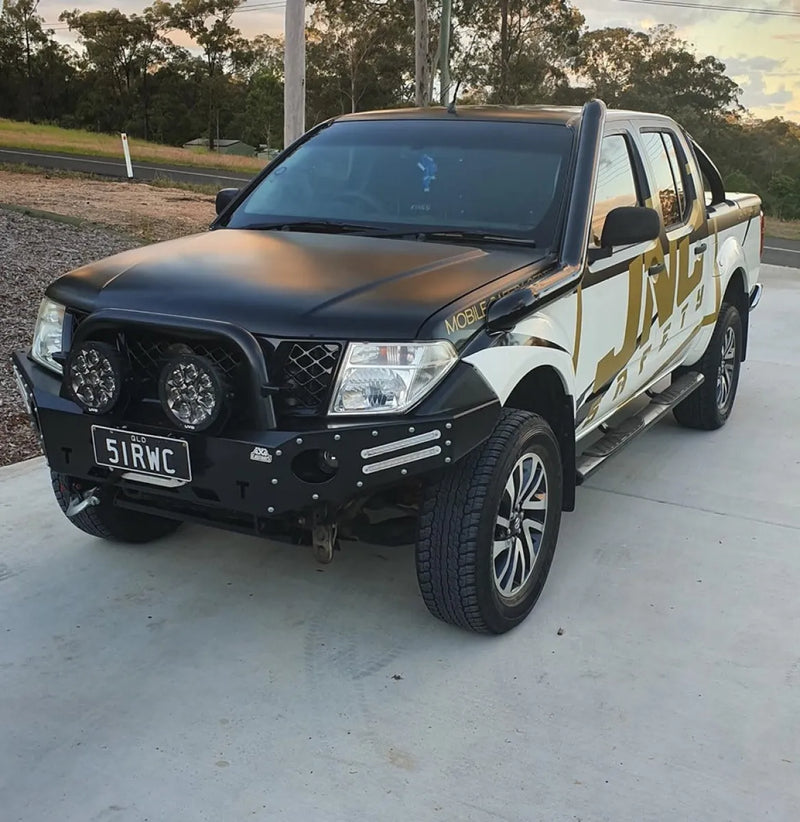 Rugged pickup truck with custom black and gold paint and steel snorkel for Nissan D40 Navara