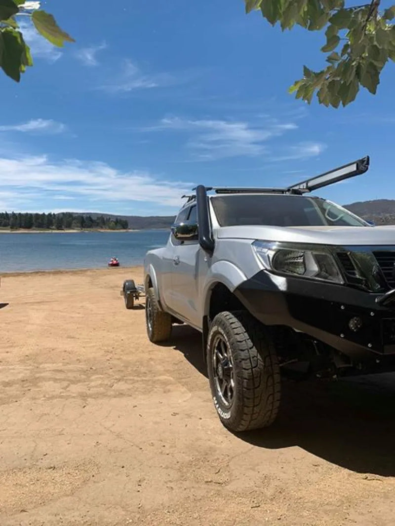 Rugged pickup truck with stainless steel snorkel parked on sandy beach scene
