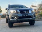 Nissan Navara NP300 stainless steel snorkel kit with headlights on parked on paved surface