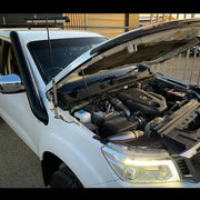 White car with open engine hood showcasing Meredith stainless steel snorkel kit for Nissan Navara NP300