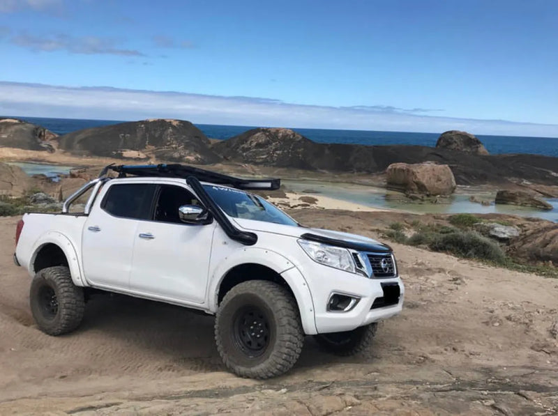 White pickup truck with stainless steel snorkel parked on rugged terrain Nissan Navara NP300
