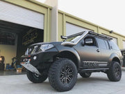 Rugged off-road SUV with oversized tires and matte black finish featuring stainless steel snorkel