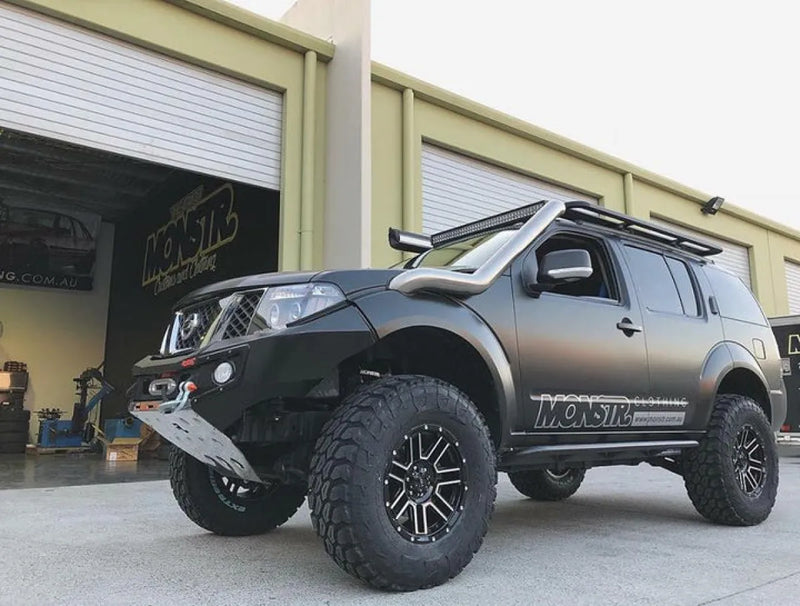 Rugged off-road SUV with oversized tires and matte black finish featuring stainless steel snorkel