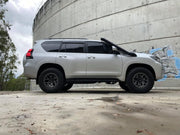 Silver Toyota Land Cruiser SUV with black wheels showcasing Meredith stainless steel snorkel kit